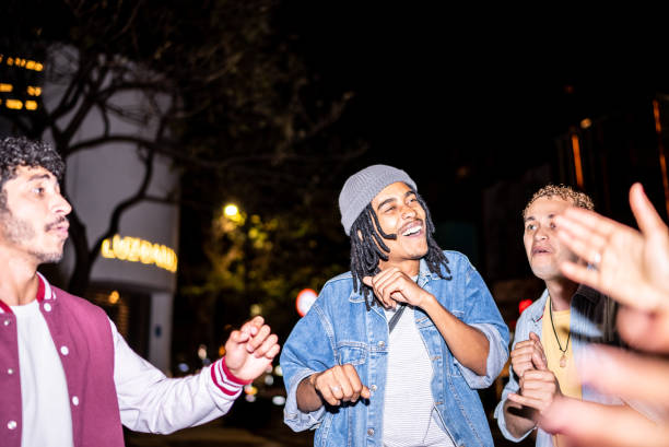 istock Group of friends dancing outside at night 1415579544