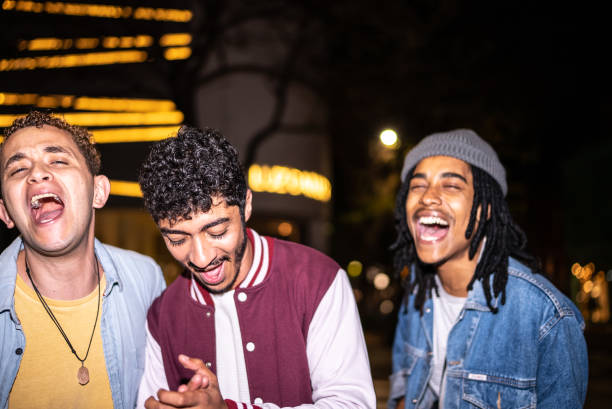 istock Friends singing in the street at night 1415580149