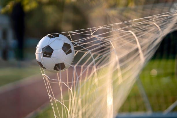 istock Soccer ball in goal 1415580721