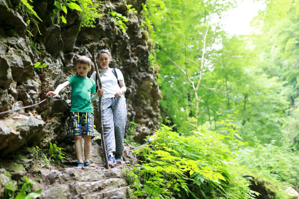istock Mother with son walking along canyon path to Rufabgo Waterfalls 1415582379