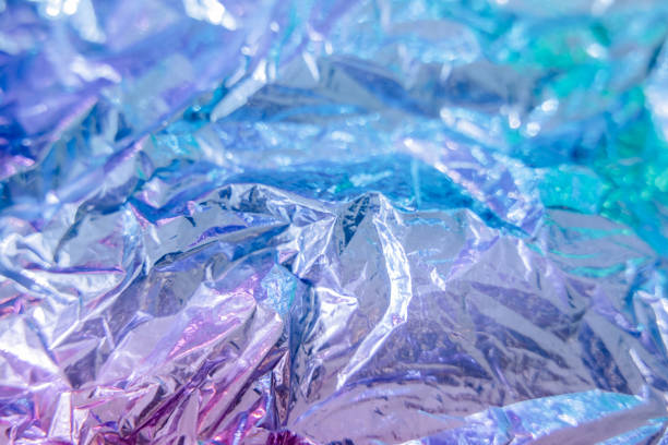 istock Iridescent foil texture background. Holographic wrinkled surface. Vibrant gradient template for design. 1415585865