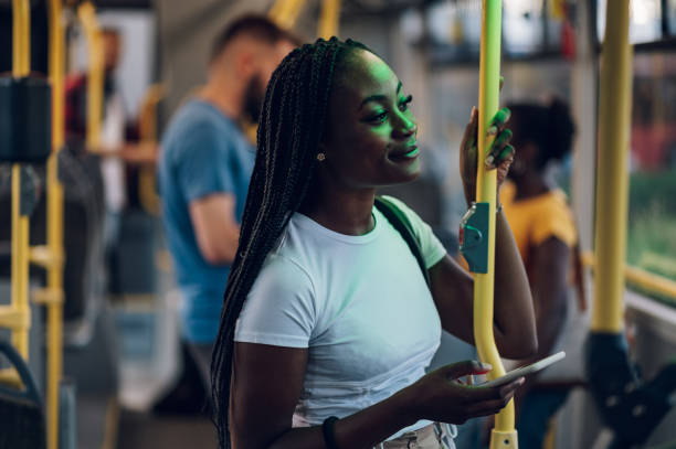 istock African american woman using smartphone while riding a bus in the night 1415585912