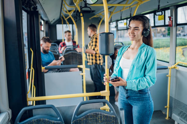 istock Woman paying a bus ticket via smartphone during a ride 1415585913