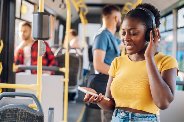 istock African american woman using smartphone while riding a bus 1415585916