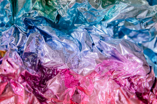 istock Iridescent foil texture background. Holographic wrinkled surface. Vibrant gradient template for design. 1415586494