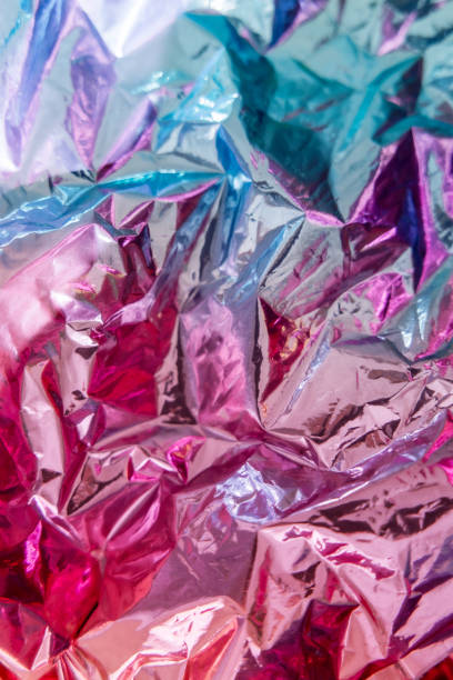 istock Iridescent foil texture background. Holographic wrinkled surface. Vibrant gradient template for design. 1415588652