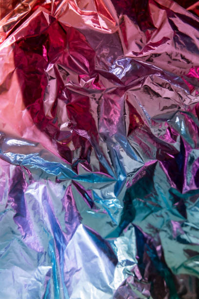 istock Iridescent foil texture background. Holographic wrinkled surface. Vibrant gradient template for design. 1415588664
