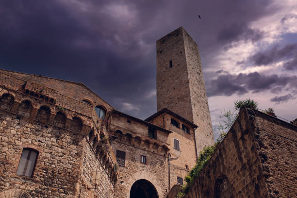 San Gimignano, Tuscany, Italy - April 21, 2025: Medieval tower in the old town. San Gimignano is famous for its medieval architecture, and its tower houses.