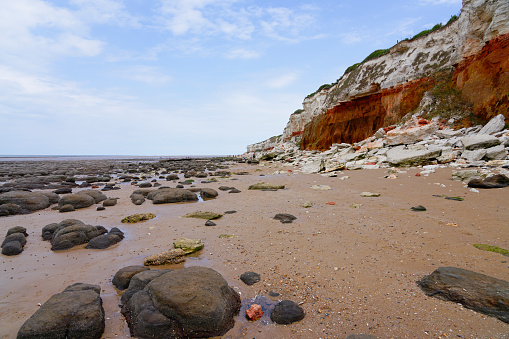 Low tide on the rock strewn beach at Hunstanton on the Norfolk coast.