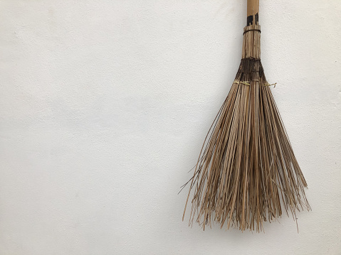 Broom made of twigs isolated on a white background