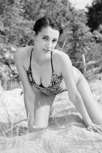 istock sensual woman sunbathes 1415595305