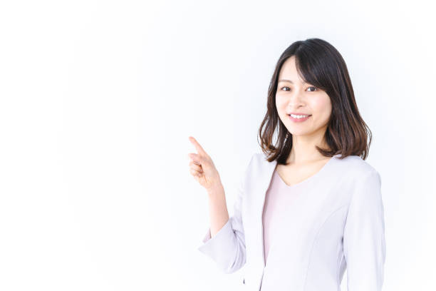 笑顔で指差すキャリアウーマン - 重要 ストックフォトと画像