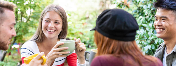 istock Horizontal banner or header with young people drinking cappuccino and espresso coffee at cafe bar garden - Happy friends talking and having fun together at hostel dehors 1415596508