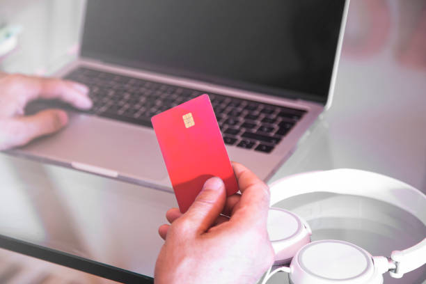 istock Man using credit card and laptop while shopping online 1415597928