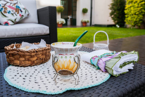 Hand-painted Argentine mate with biscuits in a background bread basket in a garden.
