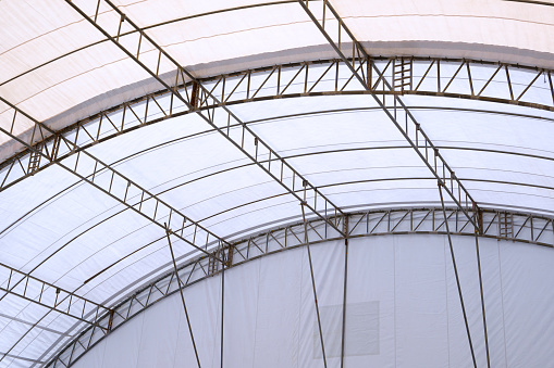View from inside of metal roof structure with canvas of large dome event tent
