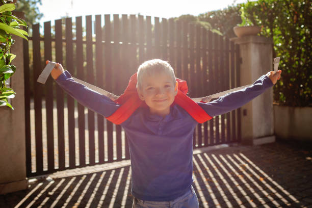 back to school. boy with backpack goes to school from home at the first day after vacation - backpack student report card education imagens e fotografias de stock