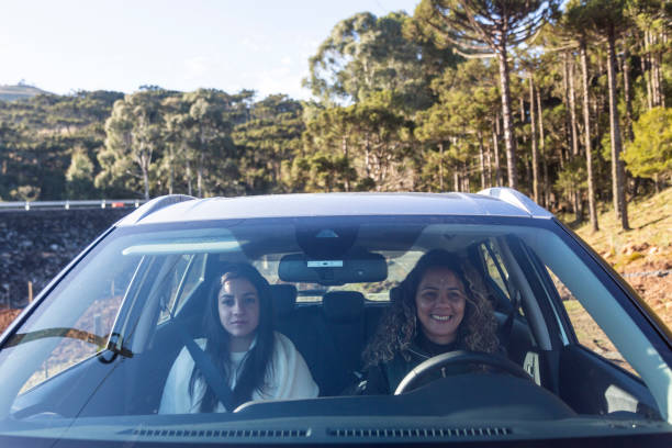 istock Two women on vacation riding in a car 1415600924