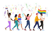 istock Pride parade vector illustration of people, homosexual couples holding rainbow signs, lgbt community activists 1415603148