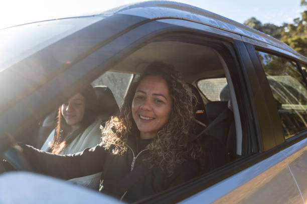 istock Two women on vacation riding in a car 1415603484