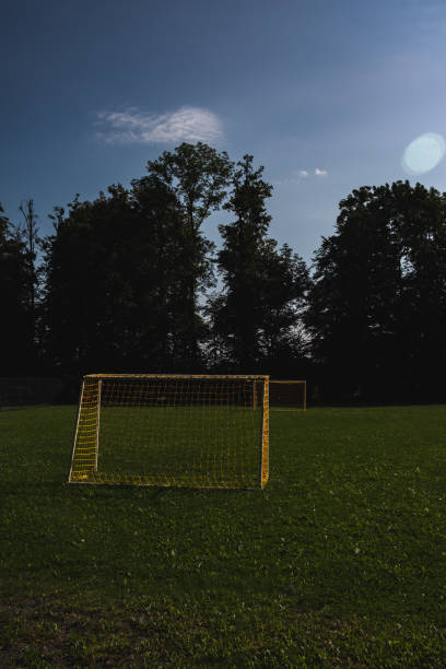 istock Two yellow soccer goals outside 1415603884