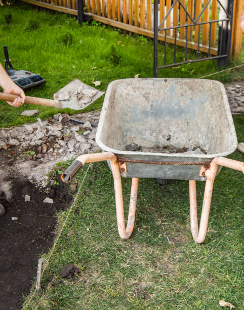 istock An empty old rusty wheelbarrow for the removal of soil during the construction of a new garden path, in the open, in summer, backyard 1415605708