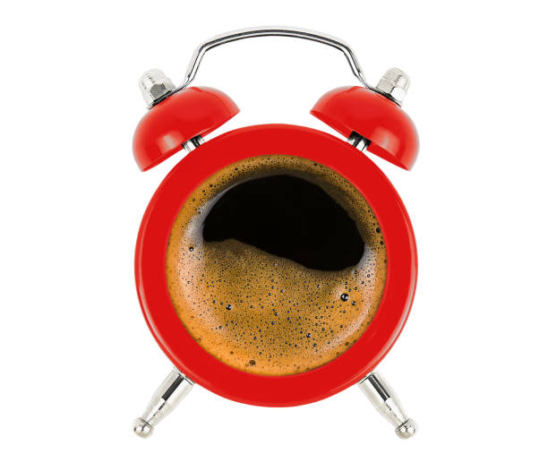 istock Red alarm clock with coffee isolated on white. 1415607509