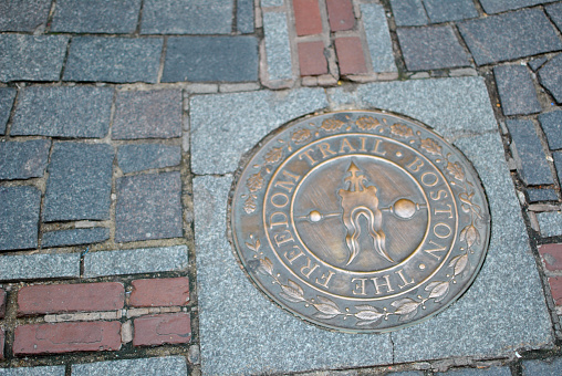 Freedom trail logo on a brick road