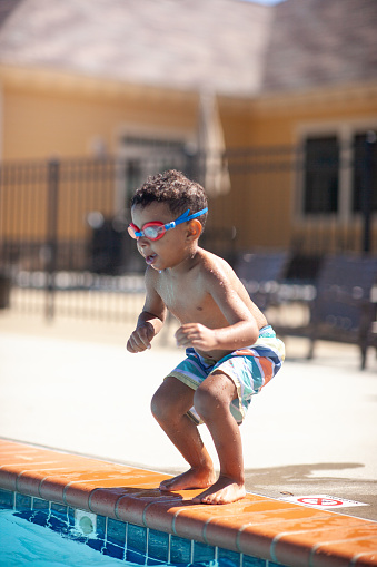 Multi race Boy learning to swim. 
Supervised by Mom. 

Shallow DOF