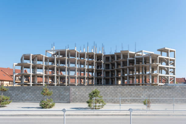 istock Construction of a multi-storey building. Concrete floors are clearly visible. Stairs, boxes of future apartments 1415611618