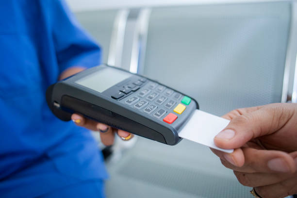 istock woman paying for a doctor's visit 1415612823