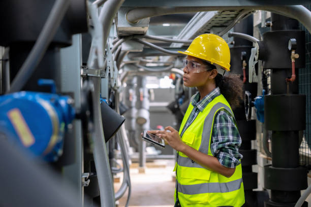 Engineer checking the cooling system of the factory air conditioner. Engineer checking the cooling system of the factory air conditioner. gas compressor stock pictures, royalty-free photos & images