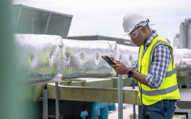 istock Engineer checking the cooling system of the factory air conditioner. 1415614279