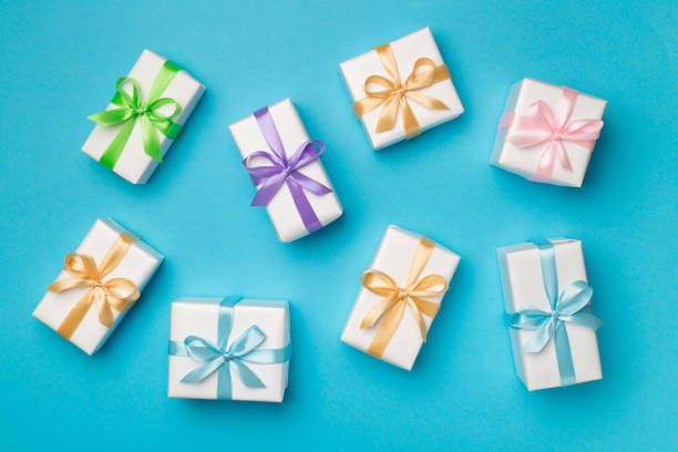 istock Colorful gift boxes on color background, top view 1415614459