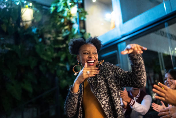 istock Group of friends dancing outside at night 1415620999