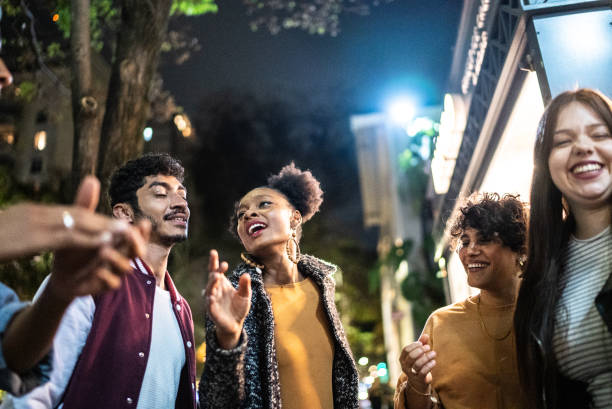 istock Friends having fun outdoors at night 1415621138