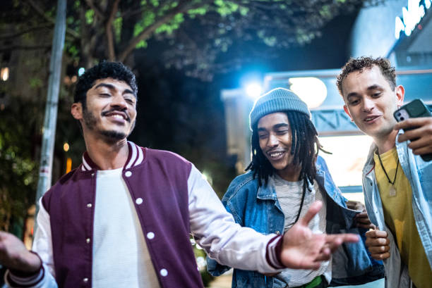 istock Group of friends dancing outside at night 1415621787