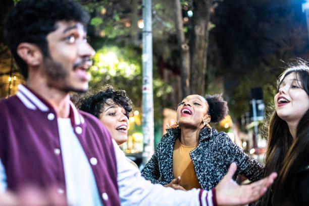 istock Friends having fun outdoors at night 1415621790