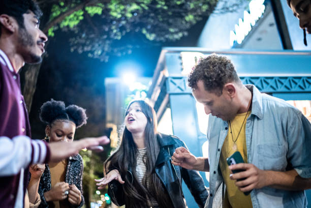 istock Group of friends dancing outside at night 1415621804