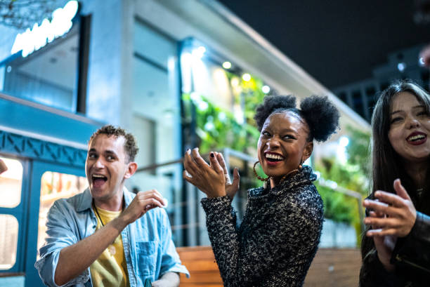 istock Group of friends dancing outside at night 1415621968