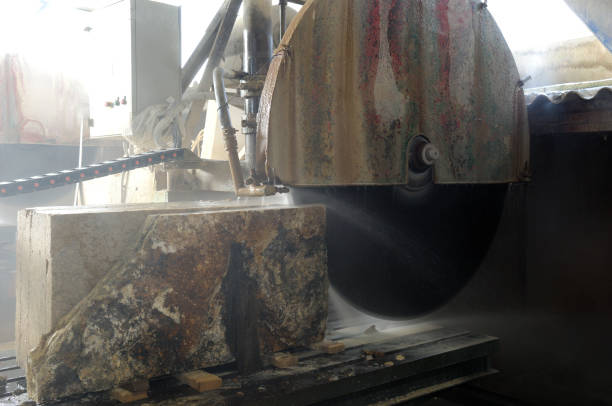 istock saw cutting a block of stone 1415621975
