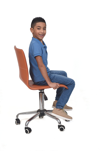 sided  view of a teen sitting on a chair on white background