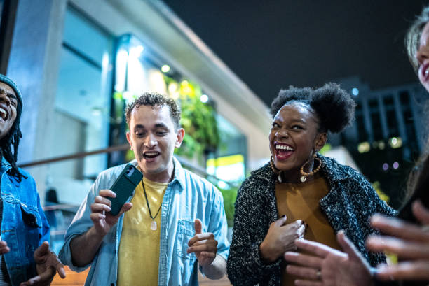 istock Group of friends dancing outside at night 1415622102