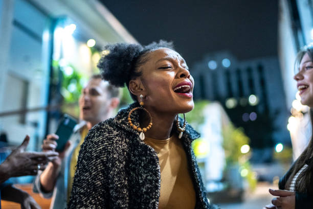 istock Group of friends dancing outside at night 1415622113