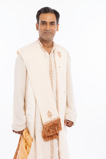 Portrait of bangali man in traditional dress at white background.