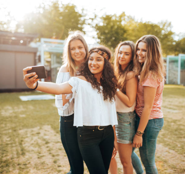 istock friends take a selfie in the park 1415624510