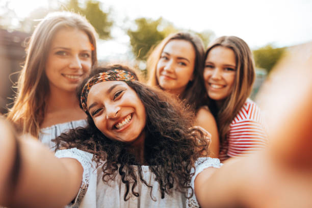 istock friends take a selfie in the park 1415625118