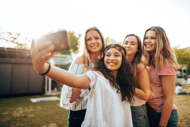 istock friends take a selfie in the park 1415625333