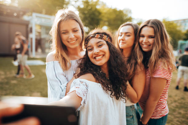 istock friends take a selfie in the park 1415625443