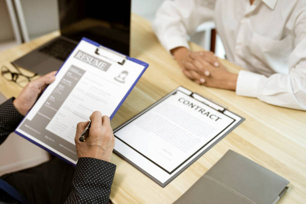 istock businessman considering resume application with an employment 1415630894